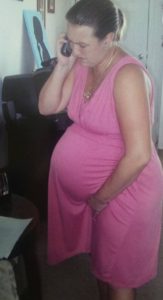 Laboring mom wearing pink dress calls midwife on phone, birth timelines
