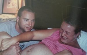 mom pushing in labor, dad smiles at her power, birth timelines